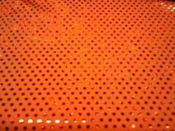 Stoffa elastica a fantasia colore arancio con pajetts. Prezzo e unità di misura al metro COD.stoffa-elastica-m7 Tecnodanza